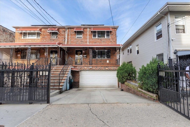 2722 Barnes Ave, Bronx, NY 10467 - multi unit property with brick siding, an attached garage, concrete driveway, stairs, and covered porch