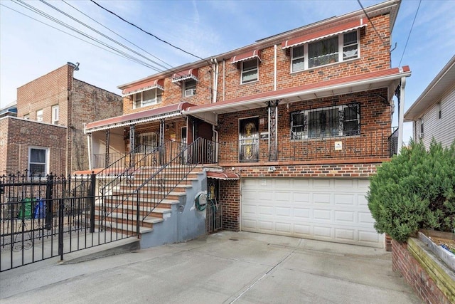 2722 Barnes Ave, Bronx, NY 10467 - view of front facade featuring brick siding, a garage, concrete driveway, and a porch