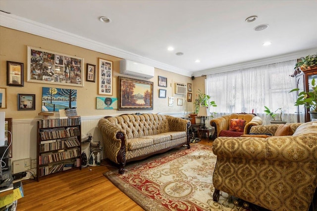 2722 Barnes Ave, Bronx, NY 10467 - living room featuring an AC wall unit, ornamental molding, wood finished floors, wainscoting, and a wall unit AC