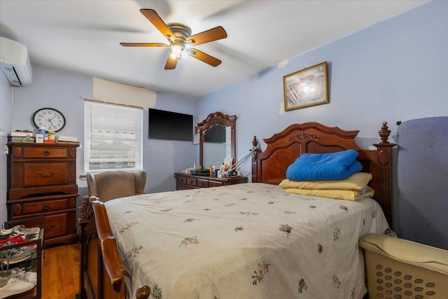 2722 Barnes Ave, Bronx, NY 10467 - bedroom with a wall unit AC, wood finished floors, and a ceiling fan