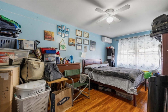 2722 Barnes Ave, Bronx, NY 10467 - bedroom with an AC wall unit and wood finished floors