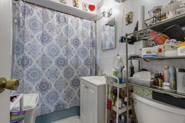 2722 Barnes Ave, Bronx, NY 10467 - bathroom with toilet, vanity, a shower with shower curtain, tile walls, and wainscoting