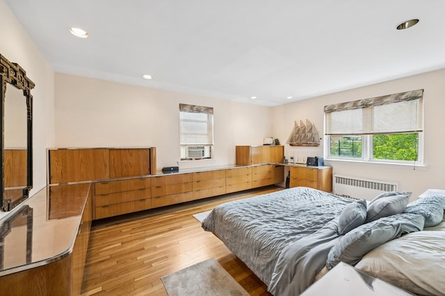 162-41 Powells Cove Blvd Unit 4G, Beechhurst, NY 11357 - bedroom featuring radiator heating unit, light wood-style flooring, recessed lighting, and cooling unit