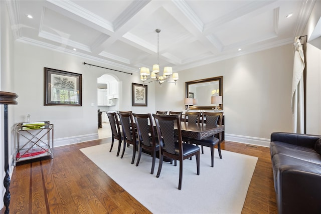 dining space with arched walkways, baseboards, a chandelier, coffered ceiling, and beamed ceiling