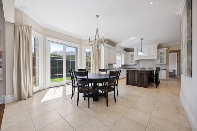dining space with a chandelier, plenty of natural light, light tile patterned floors, crown molding, and baseboards