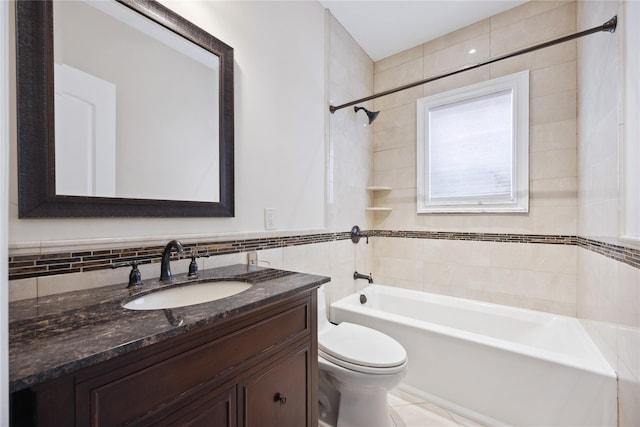 full bath with tile walls, toilet, bathing tub / shower combination, vanity, and tile patterned floors
