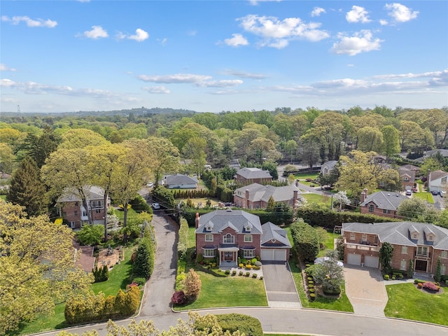 aerial view of residential area featuring a forest