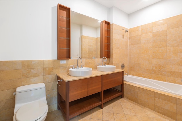 250 E 49th St Unit 5F, New York Manhattan, NY 10017 - bathroom featuring tile walls, tiled shower / bath, toilet, double vanity, and tile patterned flooring