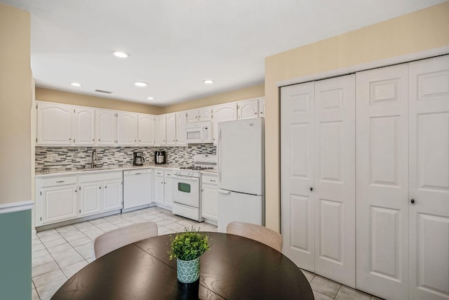 19 Hampshire Ct, Holbrook, NY 11741 - kitchen featuring white appliances, light tile patterned floors, light countertops, white cabinetry, and recessed lighting