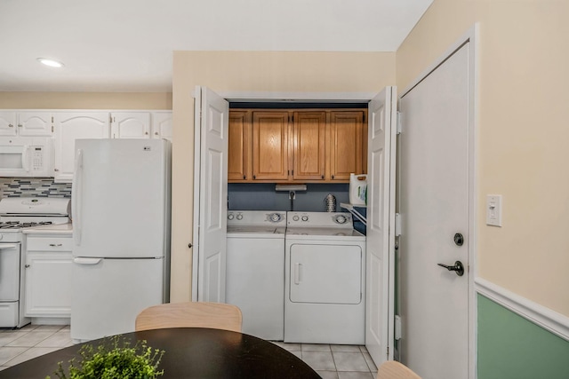 19 Hampshire Ct, Holbrook, NY 11741 - laundry room featuring cabinet space, separate washer and dryer, light tile patterned floors, and recessed lighting