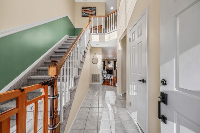 19 Hampshire Ct, Holbrook, NY 11741 - entrance foyer featuring stairway, light tile patterned floors, baseboards, and a towering ceiling