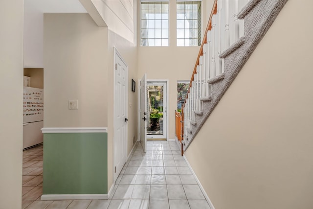 19 Hampshire Ct, Holbrook, NY 11741 - entryway with light tile patterned floors, stairs, a towering ceiling, and baseboards