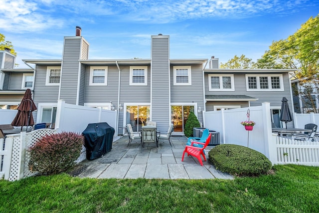 19 Hampshire Ct, Holbrook, NY 11741 - rear view of house with a patio, a chimney, and central AC