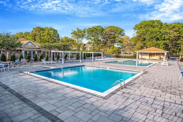 19 Hampshire Ct, Holbrook, NY 11741 - community pool featuring a patio and view of scattered trees