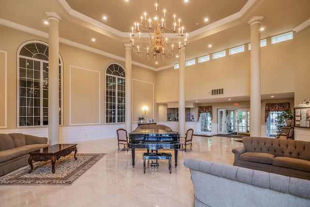 19 Hampshire Ct, Holbrook, NY 11741 - living area with ornate columns, a decorative wall, a raised ceiling, ornamental molding, and a chandelier