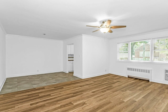 78-07 Springfield Blvd Unit B, Bayside, NY 11364 - spare room featuring radiator heating unit, ceiling fan, wood finished floors, and crown molding