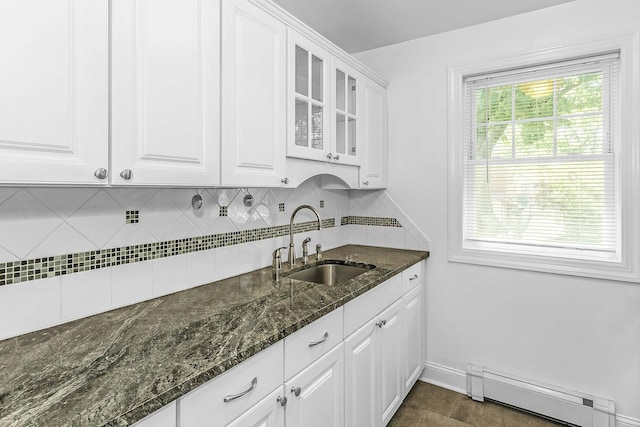 78-07 Springfield Blvd Unit B, Bayside, NY 11364 - kitchen with a baseboard radiator, decorative backsplash, white cabinets, glass insert cabinets, and dark stone countertops