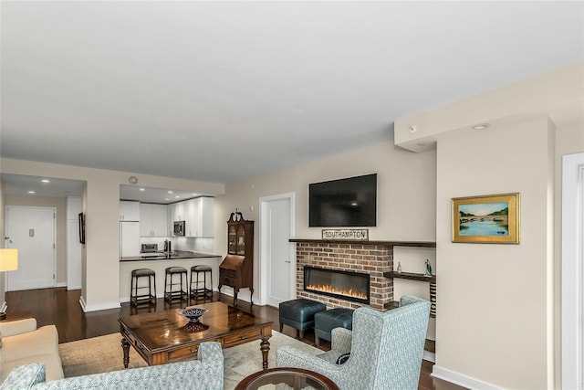 433 Main St Unit 203, Port Washington, NY 11050 - living room with dark wood finished floors, baseboards, and a fireplace