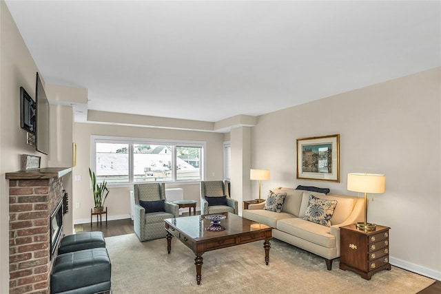 433 Main St Unit 203, Port Washington, NY 11050 - living room featuring wood finished floors, a fireplace, and baseboards