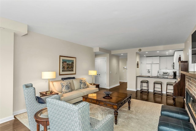 433 Main St Unit 203, Port Washington, NY 11050 - living area with dark wood-type flooring, baseboards, and recessed lighting