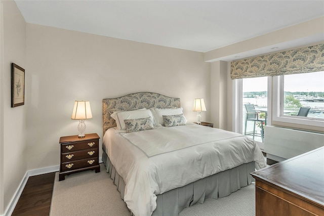 433 Main St Unit 203, Port Washington, NY 11050 - bedroom featuring light wood-style flooring, baseboards, and access to outside