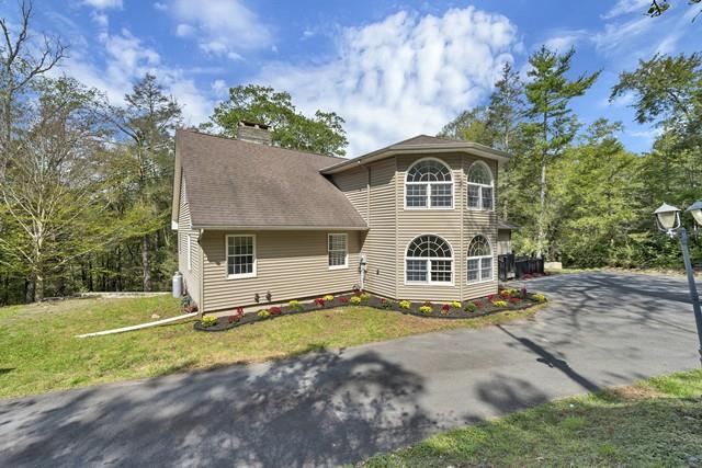 65 Old Cahoonzie Rd, Sparrowbush, NY 12780 - view of front of property with a chimney, a front lawn, and driveway