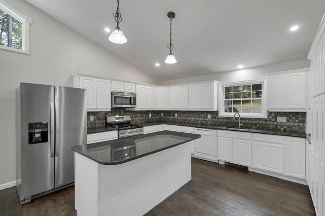 65 Old Cahoonzie Rd, Sparrowbush, NY 12780 - kitchen featuring appliances with stainless steel finishes, a sink, decorative backsplash, white cabinets, and lofted ceiling