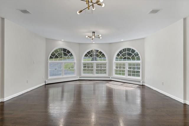 65 Old Cahoonzie Rd, Sparrowbush, NY 12780 - unfurnished living room featuring a chandelier, plenty of natural light, baseboards, and wood finished floors