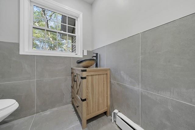 65 Old Cahoonzie Rd, Sparrowbush, NY 12780 - bathroom featuring baseboard heating, toilet, and vanity