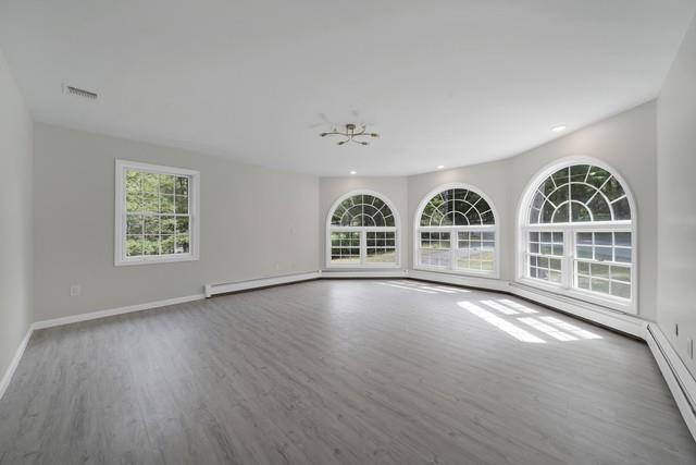 65 Old Cahoonzie Rd, Sparrowbush, NY 12780 - spare room featuring plenty of natural light, wood finished floors, a baseboard heating unit, baseboards, and recessed lighting
