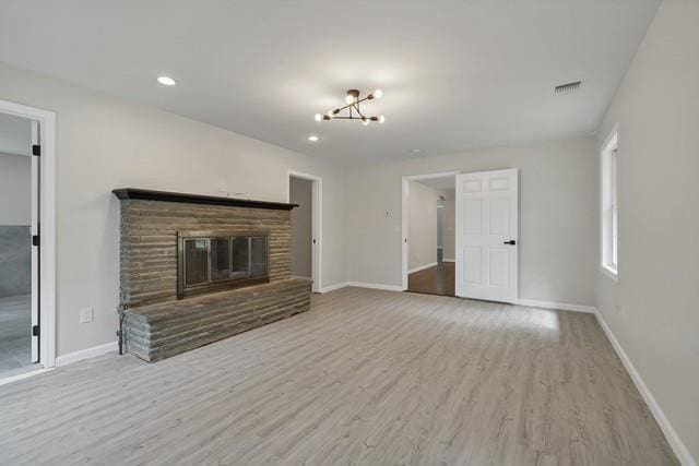 65 Old Cahoonzie Rd, Sparrowbush, NY 12780 - unfurnished living room featuring wood finished floors, baseboards, a glass covered fireplace, recessed lighting, and a chandelier