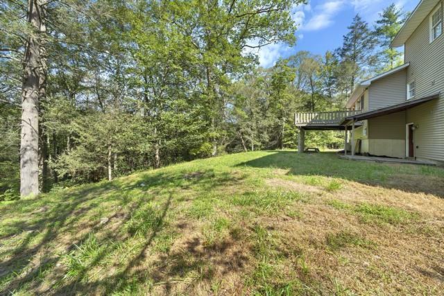 65 Old Cahoonzie Rd, Sparrowbush, NY 12780 - view of green lawn featuring a wooden deck