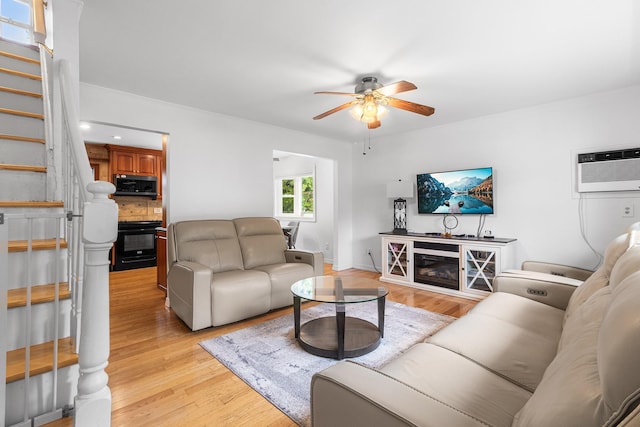 6 Cinque Dr, Farmingdale, NY 11735 - living area featuring ceiling fan, an AC wall unit, stairway, light wood-type flooring, and baseboards