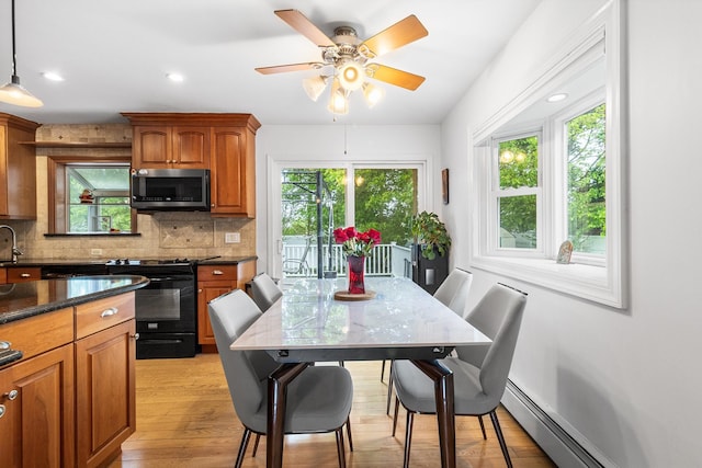 6 Cinque Dr, Farmingdale, NY 11735 - kitchen with stainless steel microwave, electric range, plenty of natural light, brown cabinets, and recessed lighting