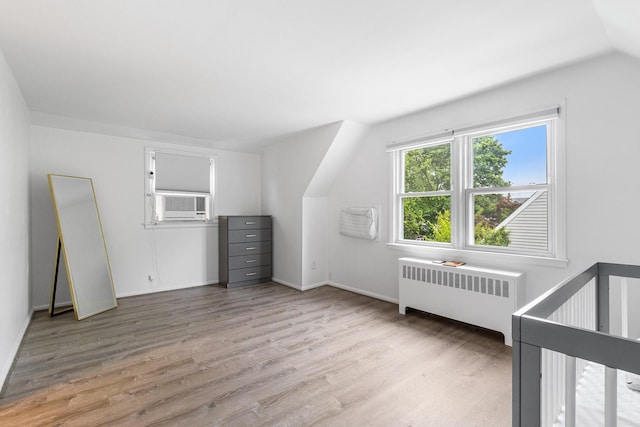 6 Cinque Dr, Farmingdale, NY 11735 - bonus room with radiator, light wood-type flooring, lofted ceiling, baseboards, and cooling unit