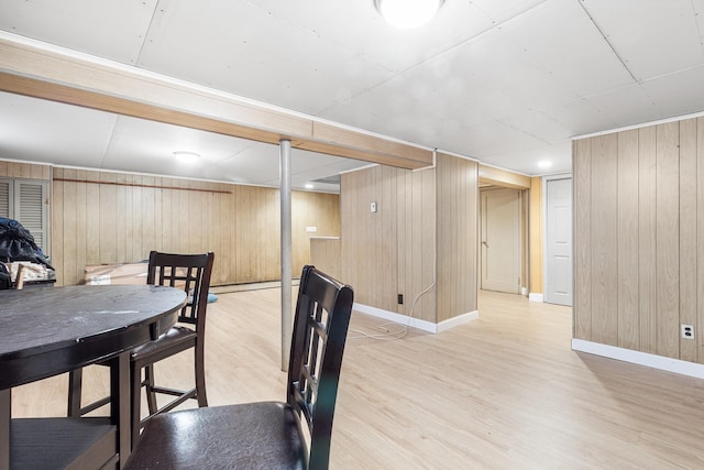 6 Cinque Dr, Farmingdale, NY 11735 - dining space featuring light wood-style floors, wood walls, and baseboards