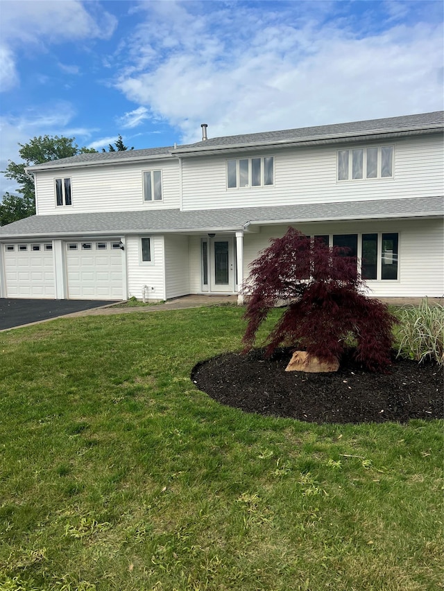 35 Thomas St, Coram, NY 11727 - view of front of home with a garage, asphalt driveway, and a front lawn