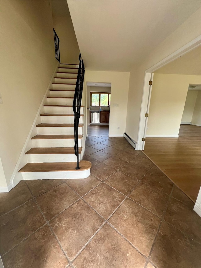 35 Thomas St, Coram, NY 11727 - stairs with baseboard heating, baseboards, and tile patterned floors
