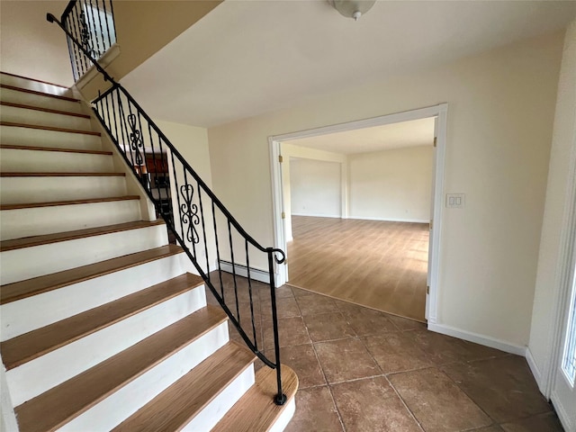 35 Thomas St, Coram, NY 11727 - staircase featuring a baseboard heating unit, baseboards, and tile patterned floors