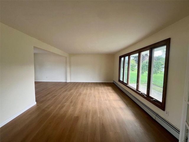 35 Thomas St, Coram, NY 11727 - spare room featuring a baseboard radiator, wood finished floors, and baseboards