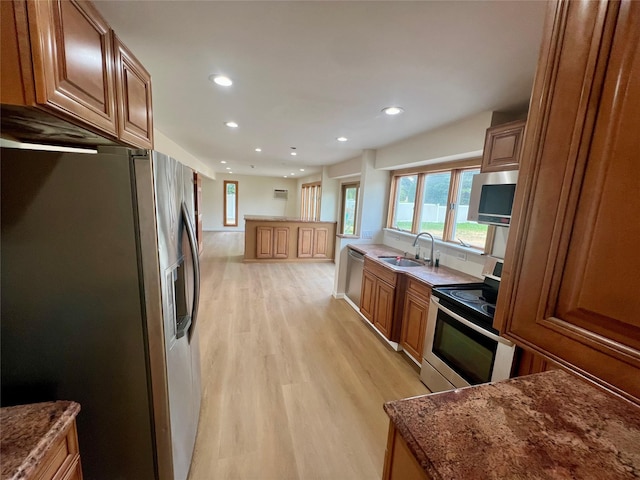 35 Thomas St, Coram, NY 11727 - kitchen with stainless steel appliances, a sink, light wood-style flooring, brown cabinets, and recessed lighting