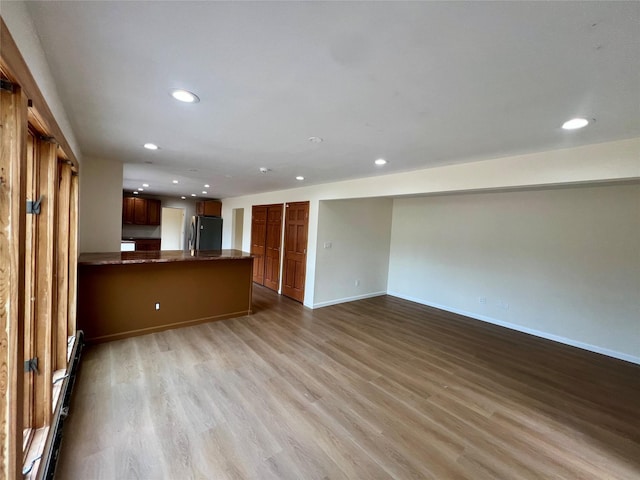 35 Thomas St, Coram, NY 11727 - unfurnished living room featuring recessed lighting, wood finished floors, and baseboards