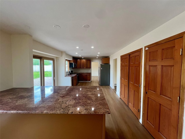 35 Thomas St, Coram, NY 11727 - kitchen featuring stainless steel appliances, wood finished floors, stone counters, recessed lighting, and a peninsula