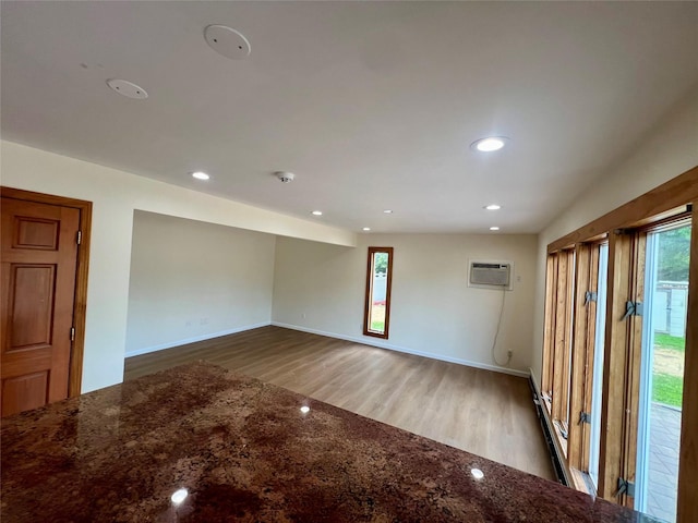 35 Thomas St, Coram, NY 11727 - unfurnished room with wood finished floors, a wall mounted AC, recessed lighting, and baseboards