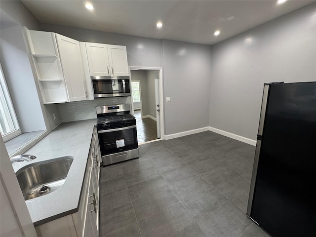 579 Van Siclen Ave, Brooklyn, NY 11207 - kitchen featuring appliances with stainless steel finishes, open shelves, a sink, white cabinetry, and recessed lighting