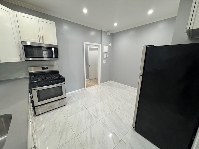 579 Van Siclen Ave, Brooklyn, NY 11207 - kitchen with appliances with stainless steel finishes, baseboards, white cabinetry, light countertops, and light marble finish flooring