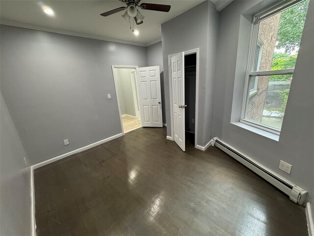 579 Van Siclen Ave, Brooklyn, NY 11207 - unfurnished bedroom with a baseboard heating unit, multiple windows, dark wood-style flooring, ornamental molding, and recessed lighting