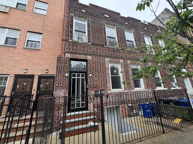 579 Van Siclen Ave, Brooklyn, NY 11207 - townhome / multi-family property featuring brick siding, a fenced front yard, and a gate