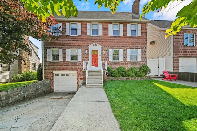 269 Hayward St, Yonkers, NY 10704 - view of front facade featuring an attached garage, driveway, a chimney, brick siding, and a front lawn