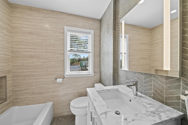 269 Hayward St, Yonkers, NY 10704 - full bathroom with tile walls, toilet, a bath, and vanity